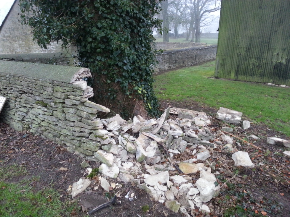 Badly damaged dry stone wall