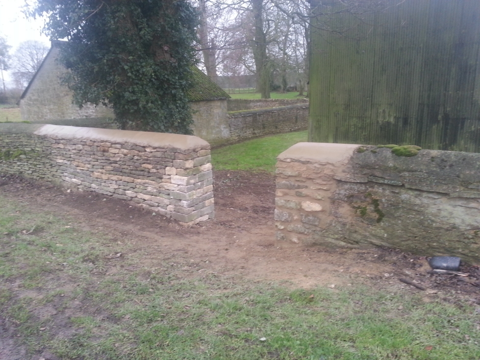 Repaired dry stone wall with cement capping