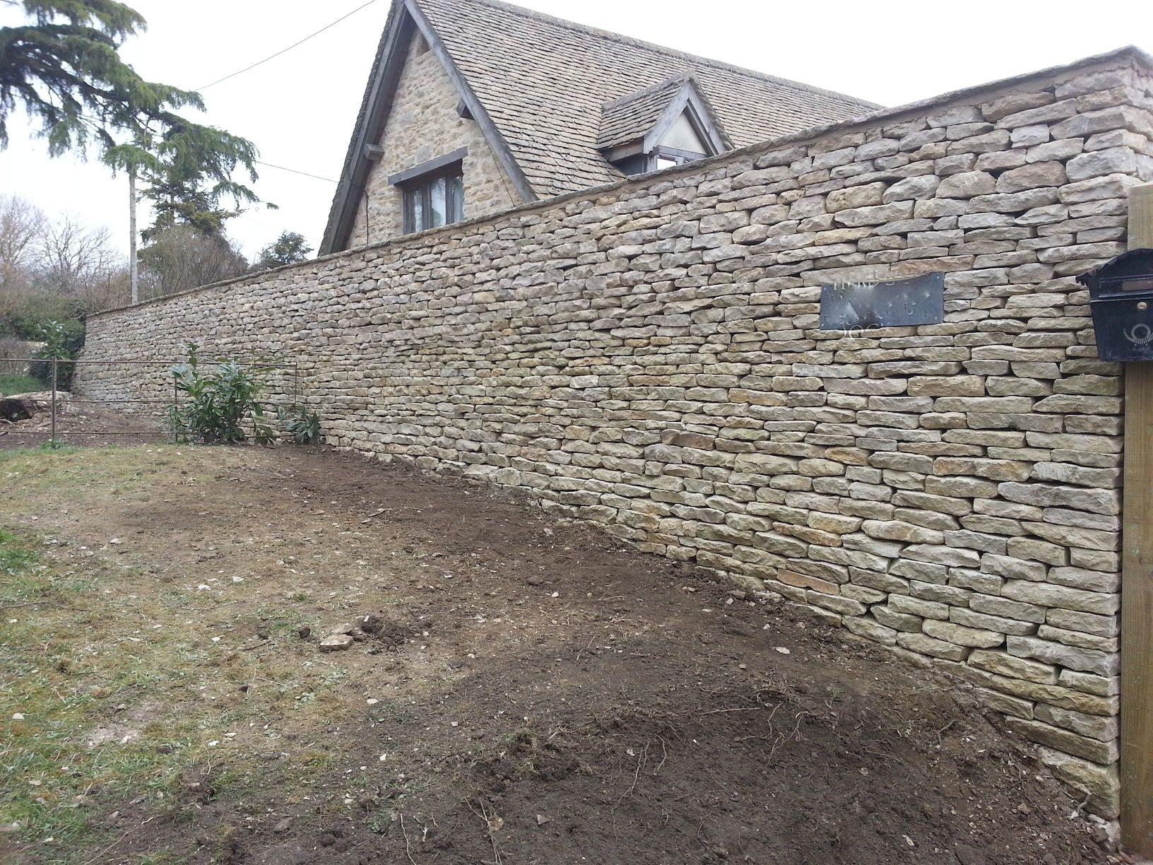 Wall showing imbedded house nameplate