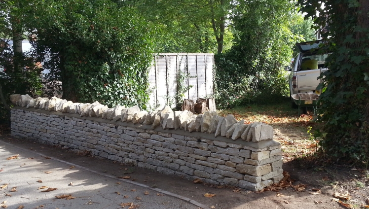 the completed repair of a dry stone wall